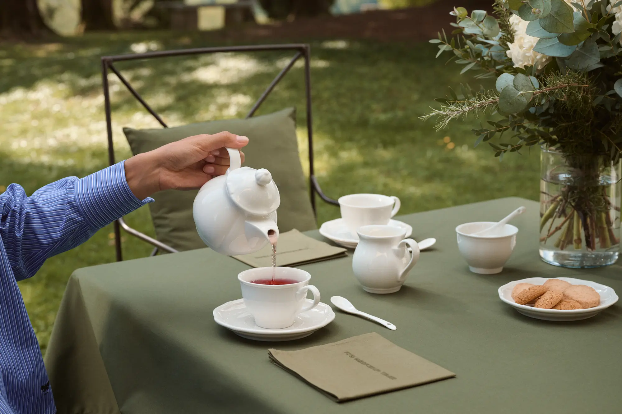 Tea being poured at an outdoor table