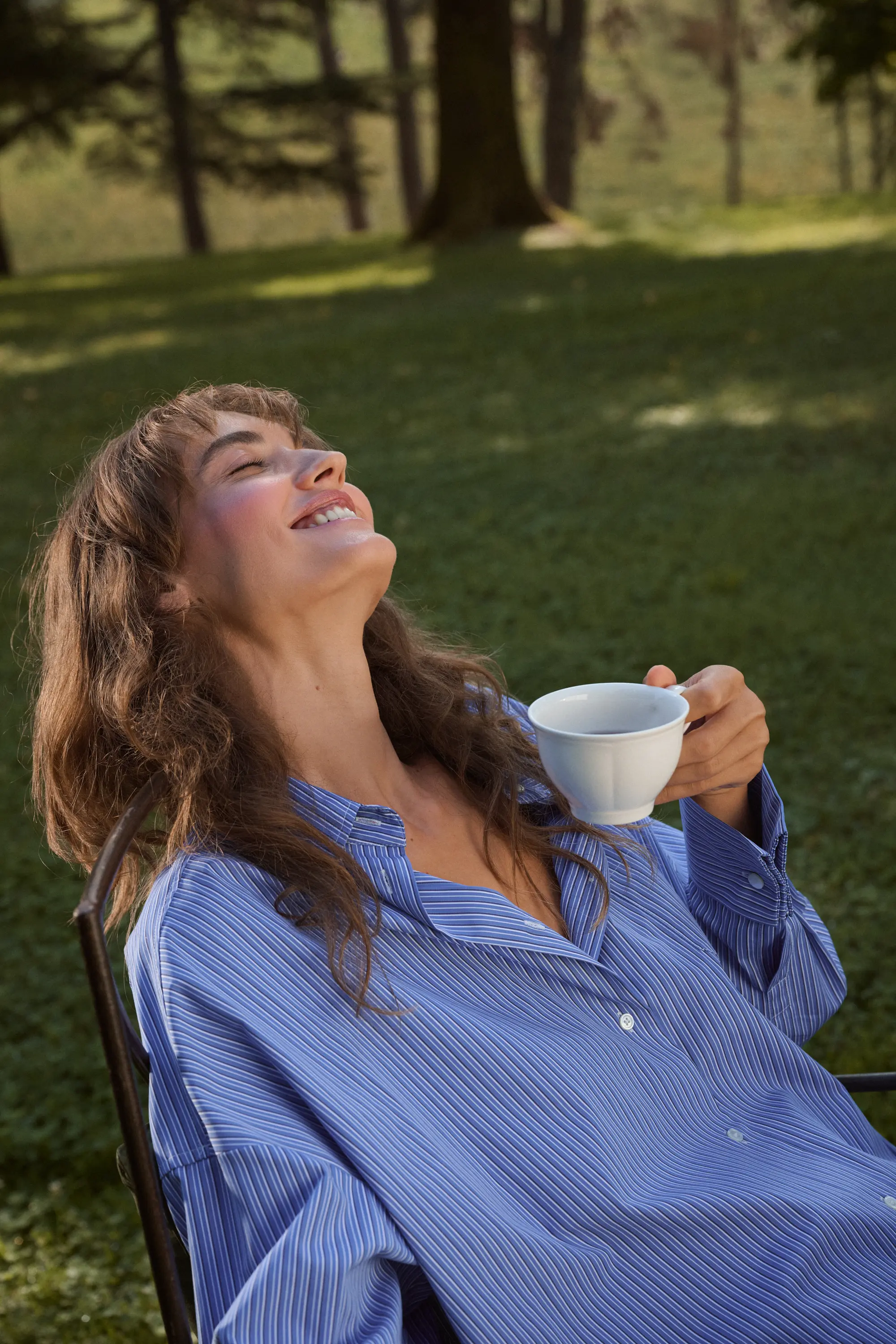 Woman smiling with a cup of tea